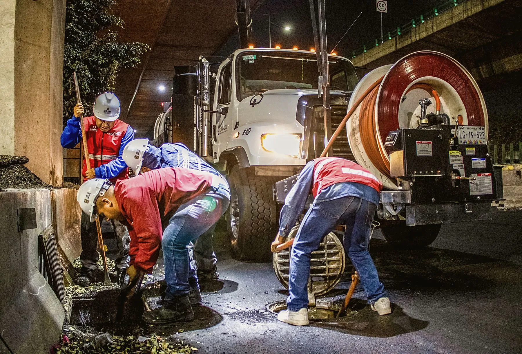 Night emergency crew at a storm drain