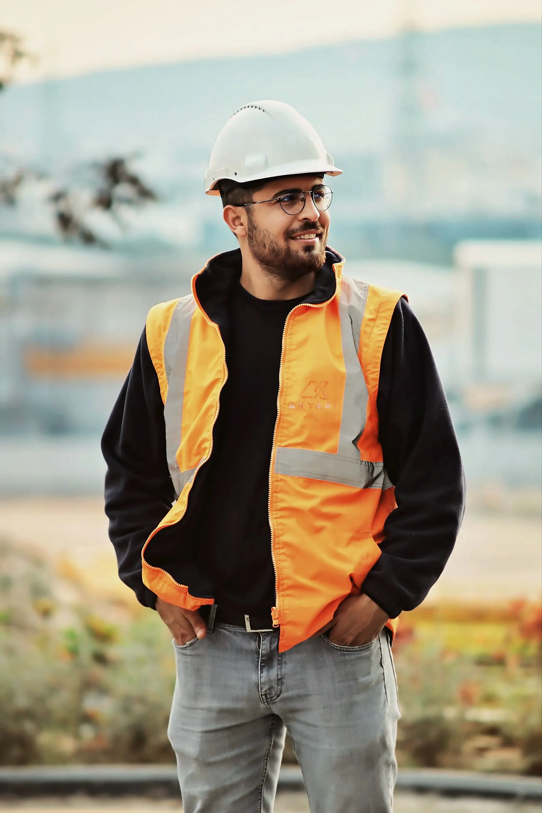 Site lead in hi-vis on a jobsite at golden hour